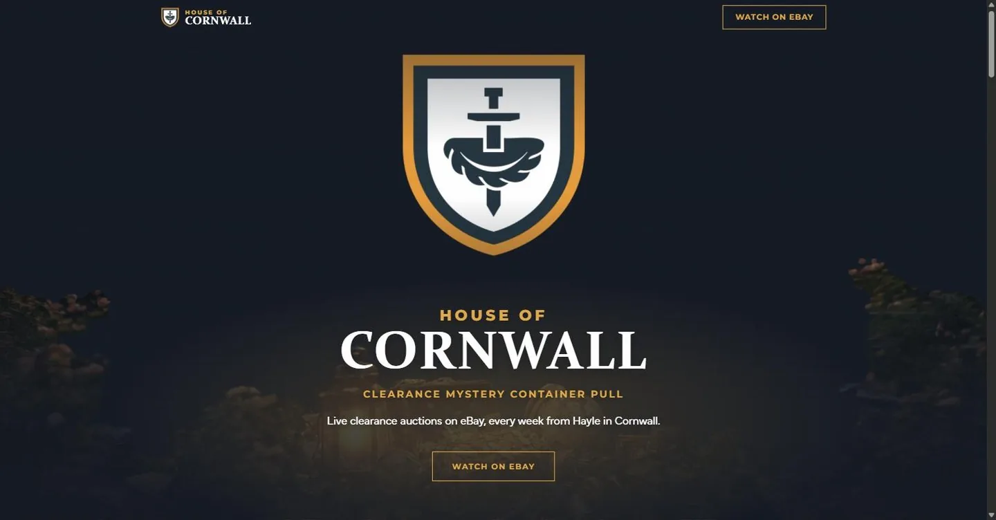 The House of Cornwall home page: the gold and navy crest above the wordmark, over a lit shipping container